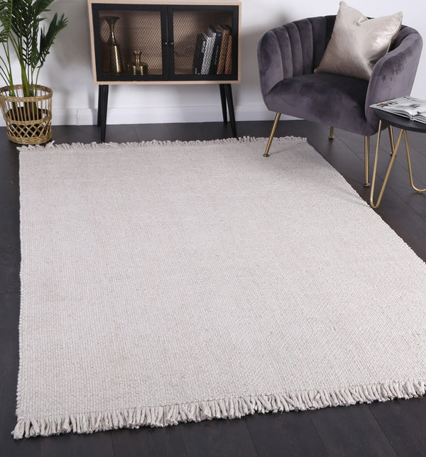 Layering Rugs: Using an Extra-Large Base Rug to Anchor Your Room